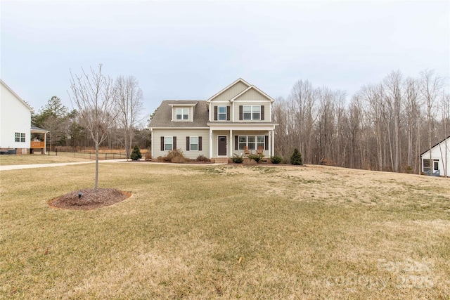 view of front facade with a front yard and covered porch