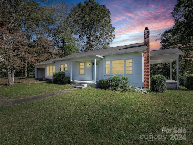 ranch-style house featuring a lawn