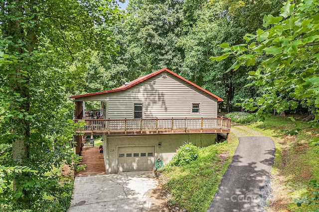 view of home's exterior featuring a garage and a deck