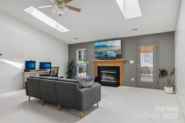 carpeted living room with ceiling fan and vaulted ceiling