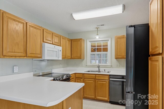 kitchen featuring kitchen peninsula, hanging light fixtures, stainless steel appliances, decorative backsplash, and sink