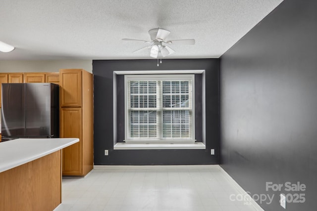 kitchen with ceiling fan and stainless steel fridge