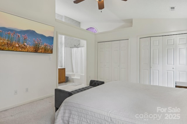 bedroom with vaulted ceiling, multiple closets, light carpet, ceiling fan, and connected bathroom