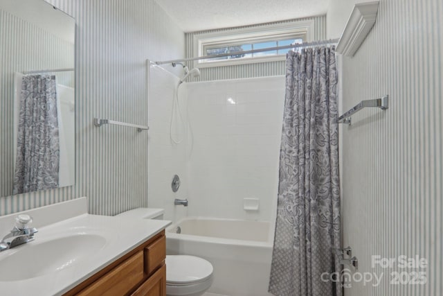 full bathroom with toilet, shower / tub combo, vanity, and a textured ceiling