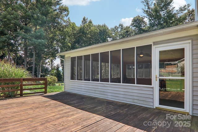 wooden deck featuring a sunroom