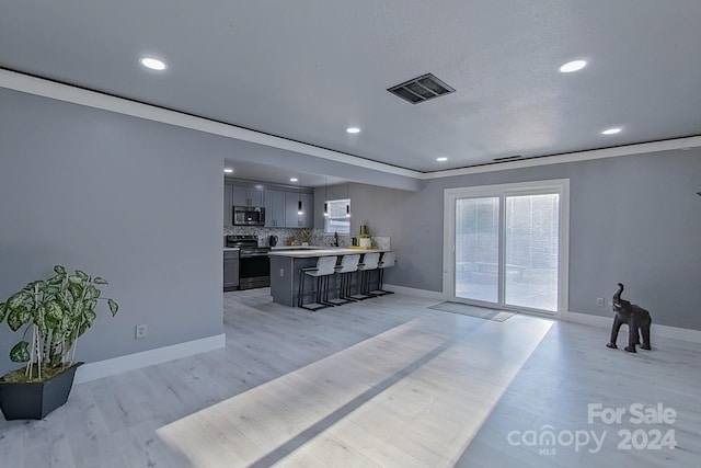 living room featuring sink and light wood-type flooring