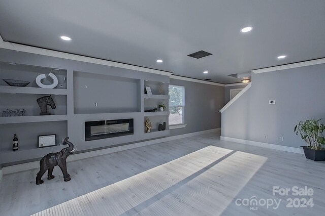 living room featuring light hardwood / wood-style floors and built in features