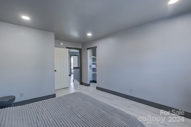 unfurnished bedroom with a closet and light hardwood / wood-style flooring