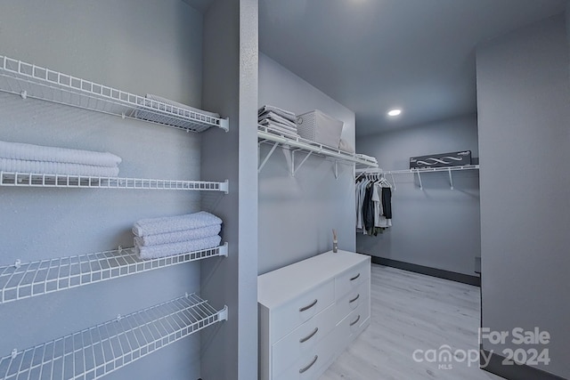 spacious closet featuring light hardwood / wood-style flooring