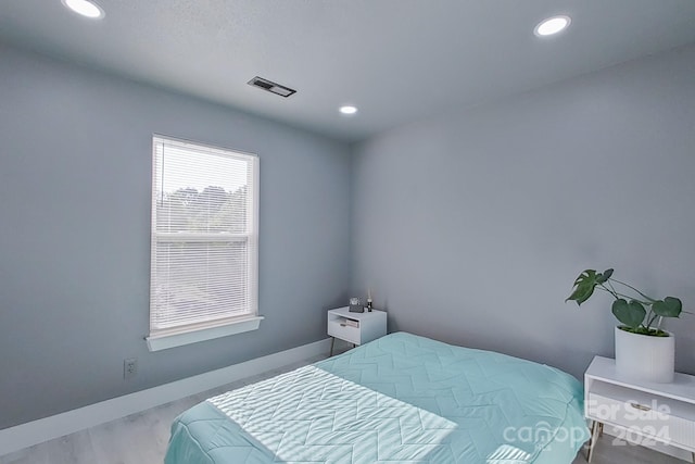 bedroom featuring recessed lighting, visible vents, baseboards, and wood finished floors