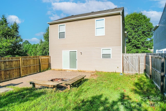 back of house with a lawn and a deck