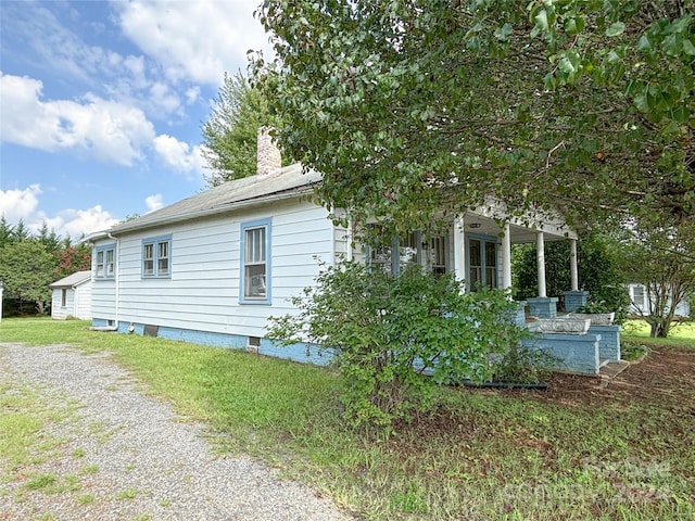 view of property exterior with a lawn