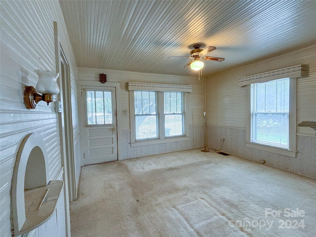 interior space featuring ceiling fan, plenty of natural light, and light colored carpet