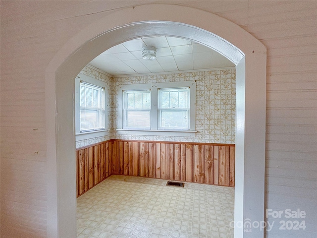 empty room featuring wood walls