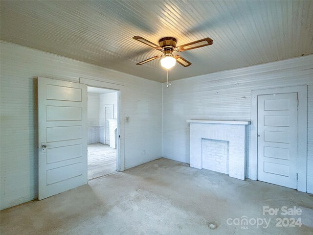 interior space with ceiling fan and a fireplace