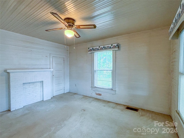 unfurnished living room with ceiling fan and a fireplace