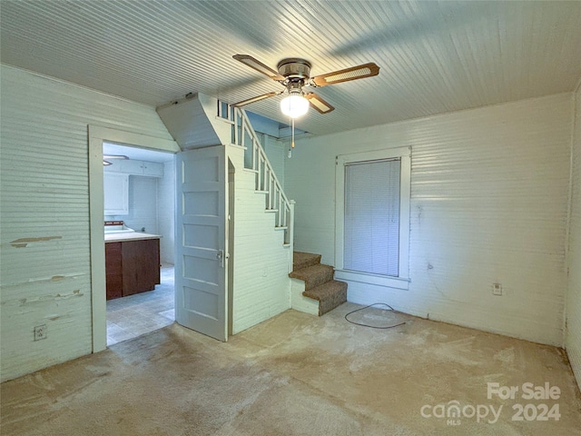 interior space with light carpet and ceiling fan