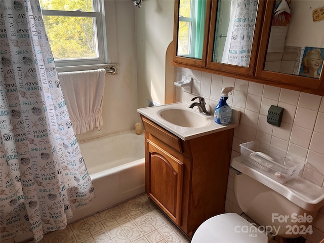 bathroom with shower / tub combo with curtain, tile walls, tasteful backsplash, toilet, and vanity