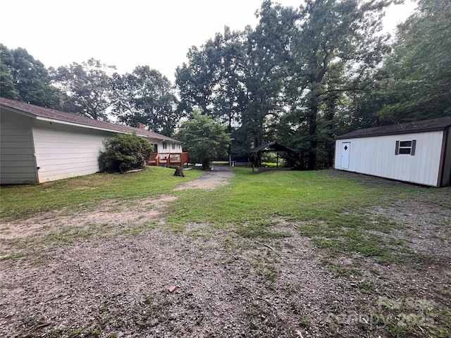 view of yard with a storage unit and a wooden deck