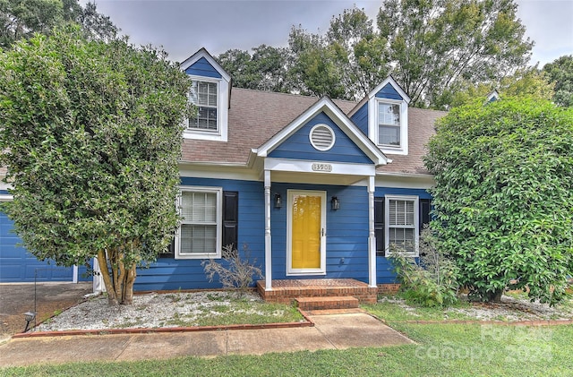 view of front of property featuring a garage and covered porch