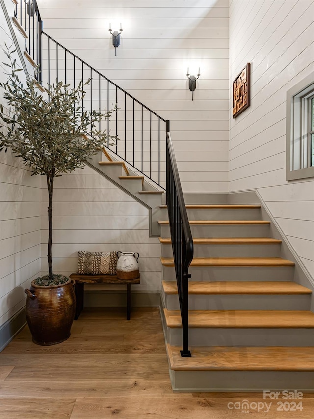 staircase with wood-type flooring