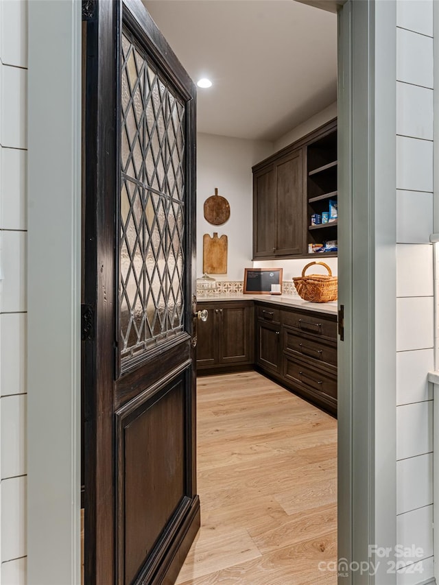 interior space with light hardwood / wood-style flooring and dark brown cabinetry