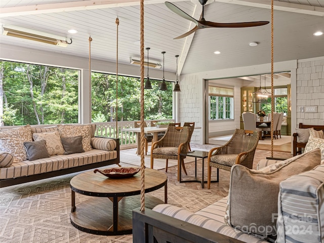 sunroom with ceiling fan, vaulted ceiling with beams, and wooden ceiling