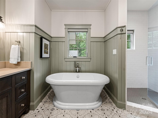 bathroom with tile patterned floors, separate shower and tub, and vanity