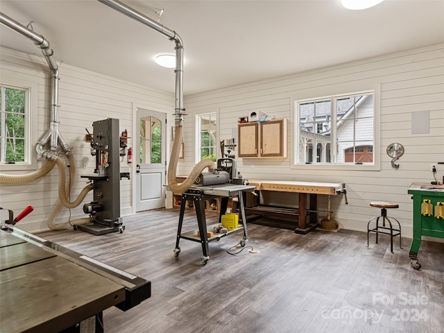 miscellaneous room with wood walls and hardwood / wood-style floors