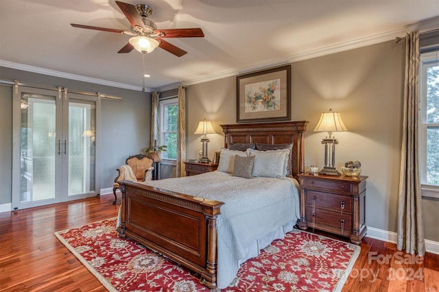 bedroom featuring crown molding, wood finished floors, and baseboards