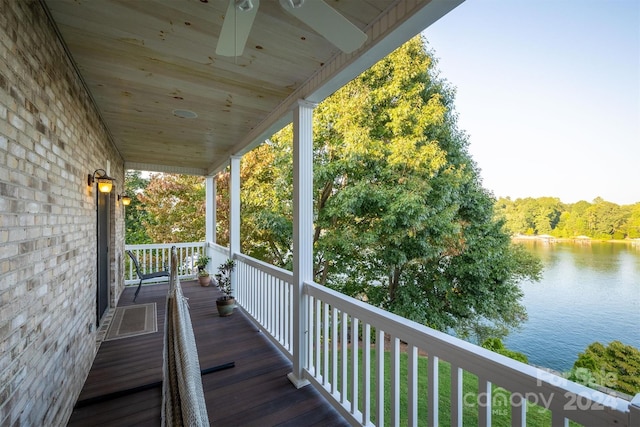 wooden deck featuring a water view and a ceiling fan