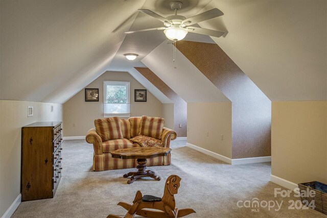 interior space featuring carpet, wallpapered walls, baseboards, an accent wall, and vaulted ceiling