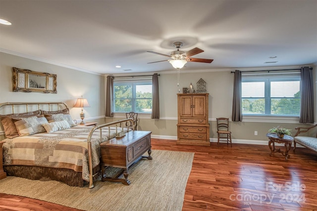 bedroom with wood finished floors, a ceiling fan, baseboards, and ornamental molding