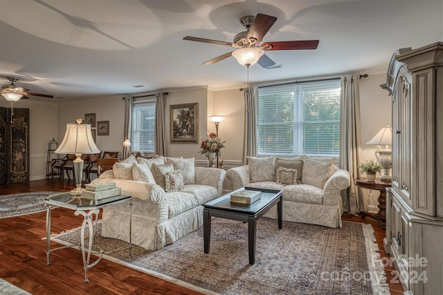 living room featuring baseboards, a ceiling fan, wood finished floors, and crown molding