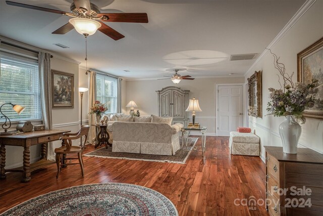 living room with dark wood-type flooring and ornamental molding