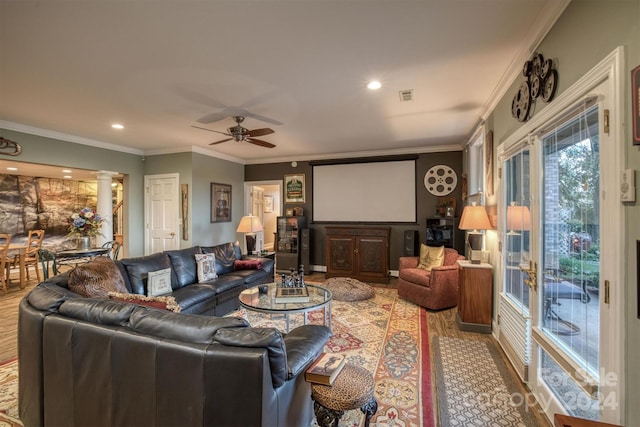 living room featuring ornate columns, ceiling fan, hardwood / wood-style floors, and ornamental molding