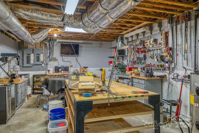 unfinished below grade area with concrete block wall, a workshop area, electric panel, and water heater