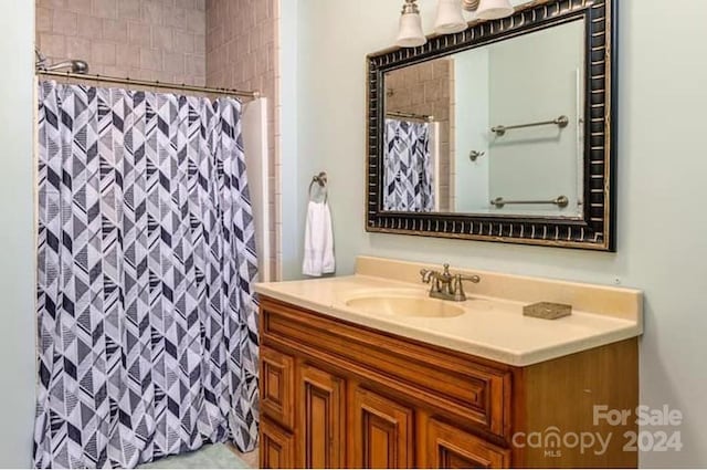 bathroom featuring vanity and a shower with shower curtain