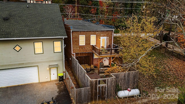 rear view of house with a garage