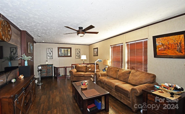 living room with ornamental molding, a textured ceiling, dark wood-type flooring, and ceiling fan