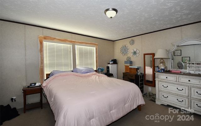 bedroom featuring ornamental molding, a textured ceiling, and dark colored carpet