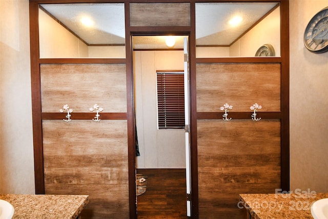 bathroom featuring vanity, lofted ceiling, and hardwood / wood-style floors