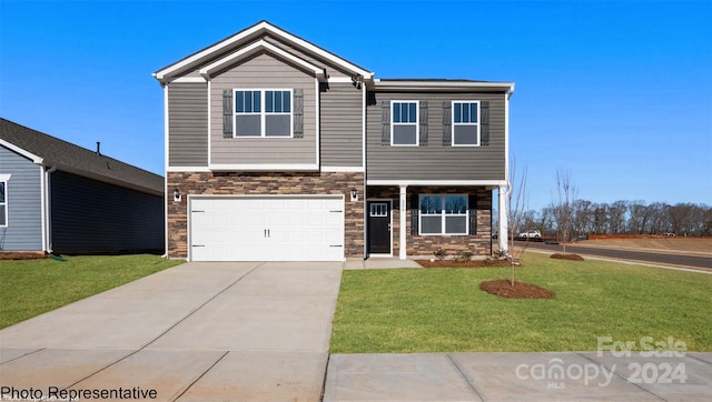 view of front of property featuring a garage and a front lawn