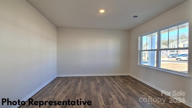 spare room with dark hardwood / wood-style flooring