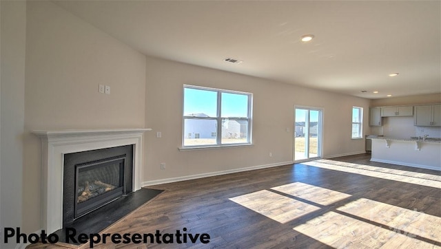 unfurnished living room featuring dark hardwood / wood-style flooring