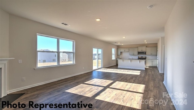 unfurnished living room with dark hardwood / wood-style flooring