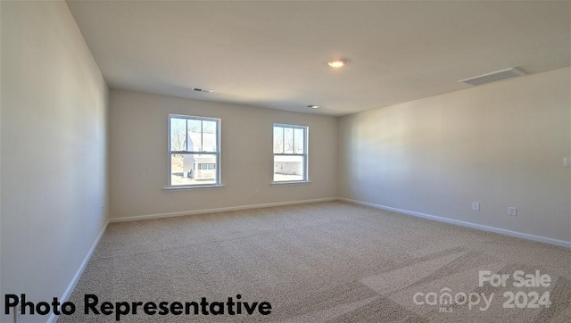 empty room featuring light carpet