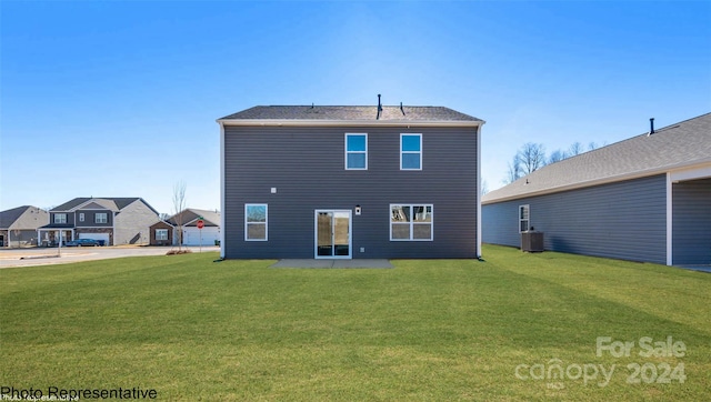 rear view of property featuring a patio, central air condition unit, and a lawn