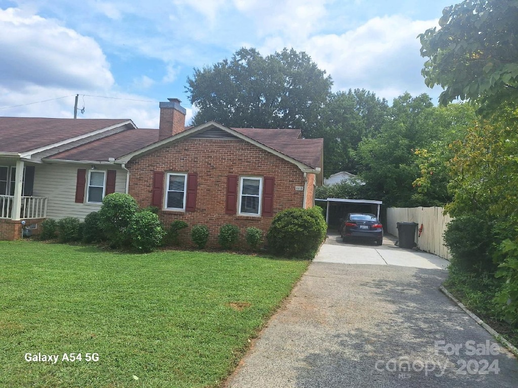 view of home's exterior featuring a yard and a carport