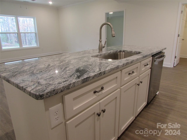 kitchen featuring white cabinetry, dishwasher, sink, light stone counters, and an island with sink